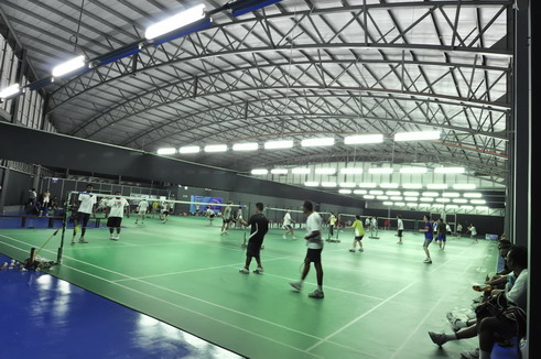 Players practising on a busy badminton court